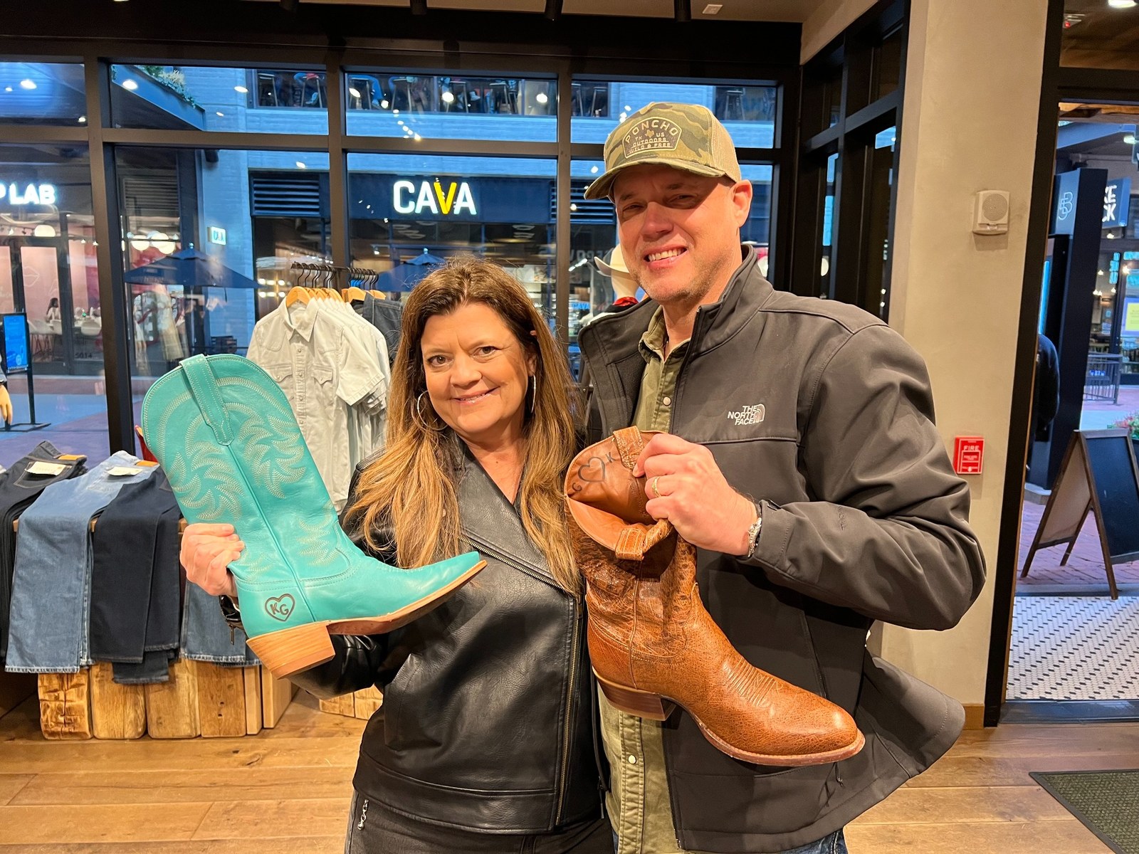 Greg and Karen holding personalized cowboy boots