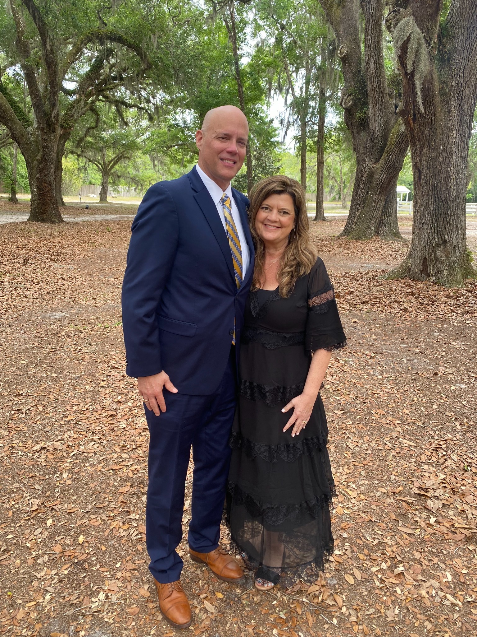 Greg and Karen dressed formally together outdoors